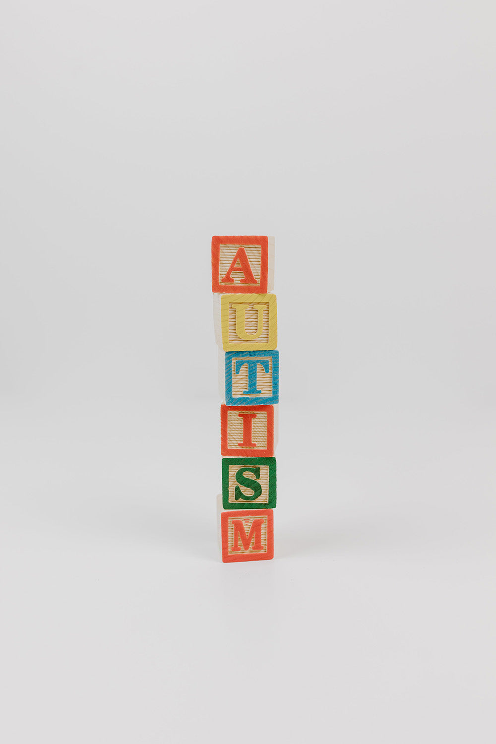 Blocks with coloured letters spelling out 'AUTISM'